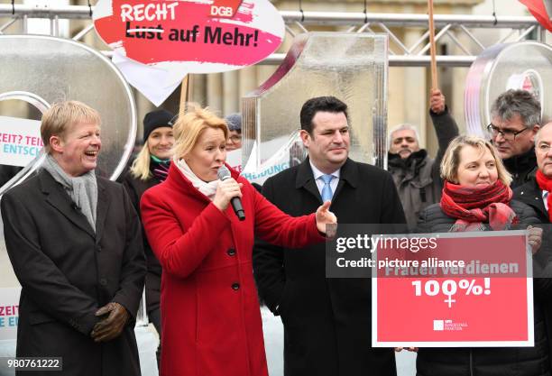 March 2018, Germany, Berlin: Franziska Giffey , German Families Minister, speaking beside Reiner Hoffmann , DGB chairman; and Hubertus Heil , German...