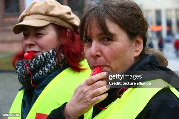 March 2018, Germany, Gera: Ramona Teske and Steffi Ackermann, both public service employees of Gera's city administration, blow a whistles during a...