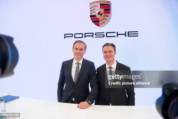 March 2018, Germany, Stuttgart: Oliver Blume , CEO of Porsche AG, and Lutz Meschke, deputy chairman, appear at an annual press conference to present...