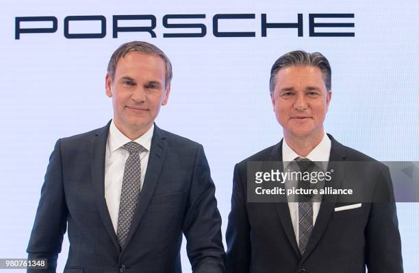 March 2018, Germany, Stuttgart: Oliver Blume (l9, CEO of Porsche AG, and Lutz Meschke, deputy chairman, appear at an annual press conference to...