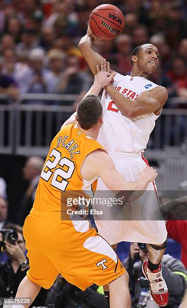 Evan Turner of the Ohio State Buckeyes tries to pass the ball as Steven Pearl of the Tennessee Volunteers defends during the midwest regional...