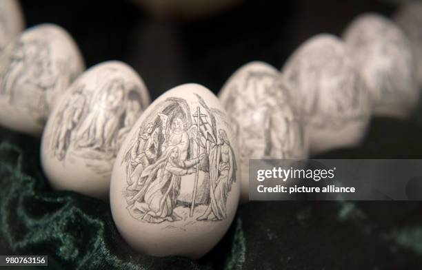 March 2018, Germany, Sonnenbuehl: Turkey eggs decorated with pencil drawings by the artist Monika-Satalino Weber are displayed in a vitrine at the...