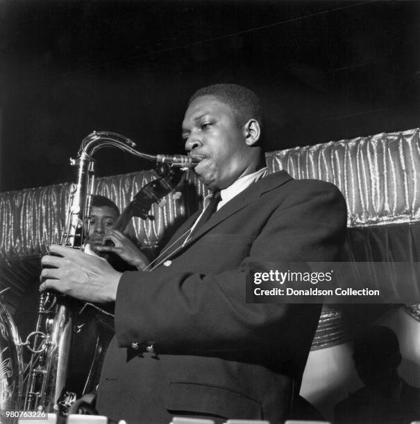 Jazz saxophonist John Coltrane performs onstage at Birdland in 1955 in New York, New York.