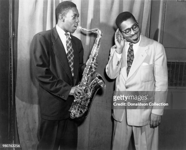 Jazz saxophonist John Coltrane poses for a portrait with Dizzy Gillespie on January 19, 1951 in New York, New York.