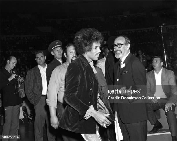 Musician Jimi Hendrix at a tribute to Martin Luther King, Jr. With Jerry Wexler backstage at Madison Square Garden on June 28, 1968 in New York.