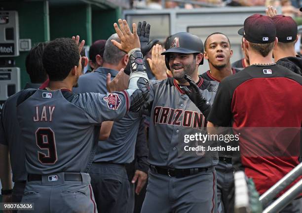 Alex Avila of the Arizona Diamondbacks is greeted by teammates in the dugout after hitting a two run home run in the third inning during the game...