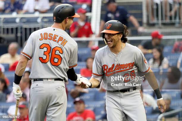 Colby Rasmus of the Baltimore Orioles celebrates with Caleb Joseph after hitting a solo home run in the second inning against the Washington...