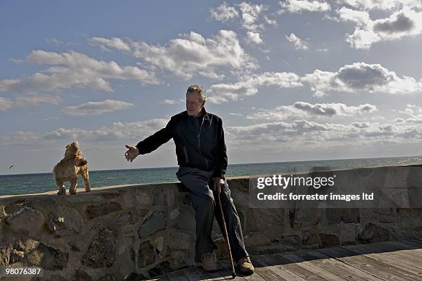 Former President George H.W. Bush with pet dog Bibi during a portrait session for Parade Magazine at home in Kennebunkport, Maine on September 29,...