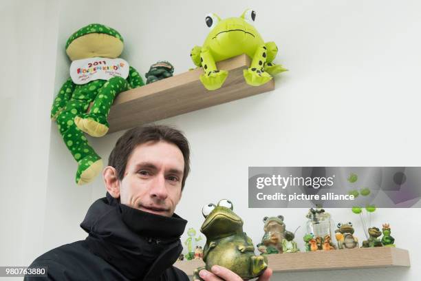 March 2018, Germany, Schierke: Marc Kinkeldey, weather service technician at the German Weather Service , shows a collection of weather frogs in a...