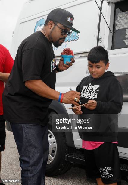 Rap Artist Ice Cube signs an autograph during the Young3 Basketball Clinic and Tournament on June 21, 2018 in Houston, Texas.