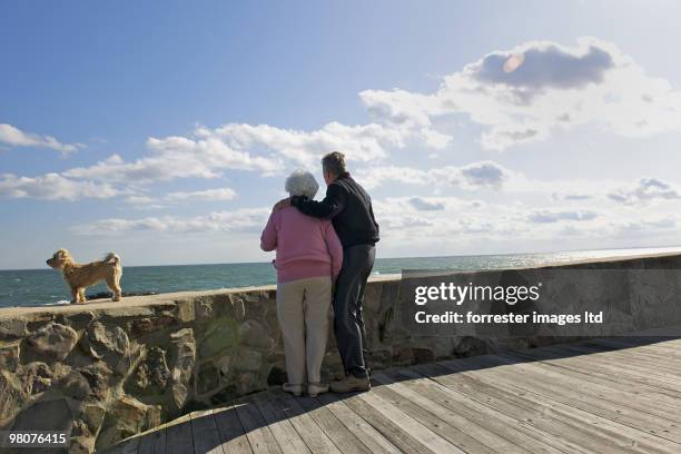 Former President George H.W. Bush with former First Lady Barbara Bush with their pet dog Bibi during a portrait session for Parade Magazine at their...