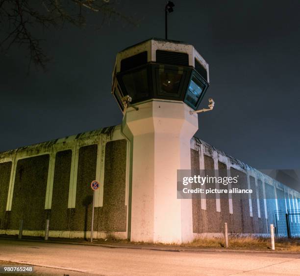 March 2018, Germany, Berlin: Lights brighten the wall of the Ploetzensee Prison in the evening. Photo: Paul Zinken/dpa