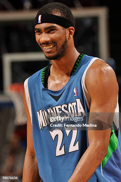 Corey Brewer of the Minnesota Timberwolves laughs with a teammate against the Orlando Magic during the game on March 26, 2010 at Amway Arena in...