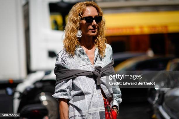 Elina Halimi wearsa shirt, red tartan checked pants, a red bag with fringes, outside Issey Miyake, during Paris Fashion Week - Menswear Spring-Summer...