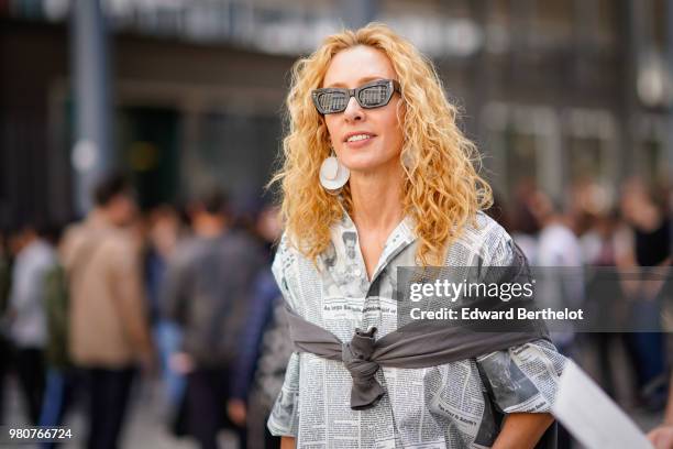 Elina Halimi wearsa shirt, red tartan checked pants, a red bag with fringes, outside Issey Miyake, during Paris Fashion Week - Menswear Spring-Summer...