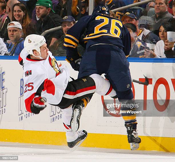 Thomas Vanek of the Buffalo Sabres checks Chris Neil of the Ottawa Senators in their game on March 26, 2010 at HSBC Arena in Buffalo, New York.