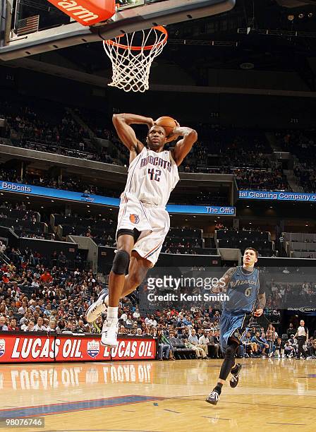 Theo Ratliff of the Charlotte Bobcats goes for the dunk as Mike Miller of the Washington Wizards trails the play on March 26, 2010 at the Time Warner...
