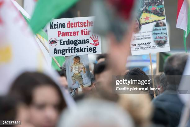 Dpatop - Kurds protesters hold up a poster with the inscription 'no German tanks for Erdogan's war of aggression' during a demonstration against the...