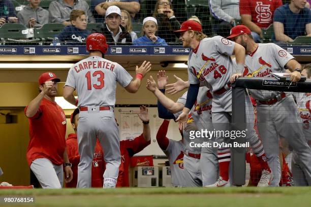 Matt Carpenter of the St. Louis Cardinals celebrates with teammates after hitting a home run in the first inning against the Milwaukee Brewers at...