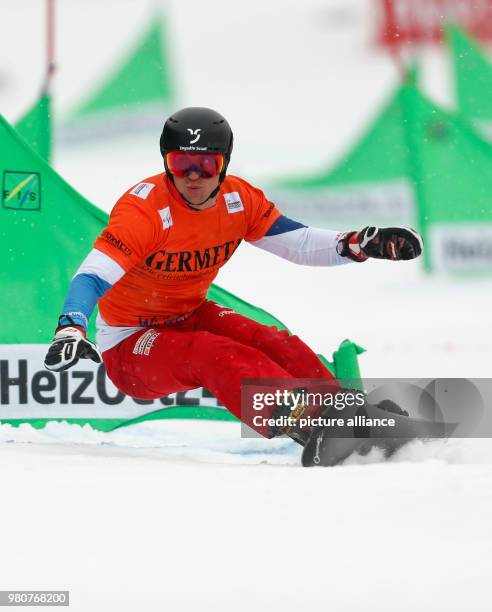 March 2018, Germany, Winterberg: Snowboard World Cup, parallel slalom, men's single. Dmitry Loginov of Russia in action. Photo: Ina Fassbender/dpa