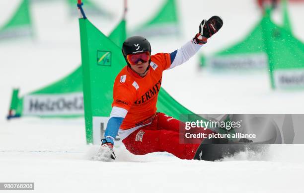 March 2018, Germany, Winterberg: Snowboard World Cup, parallel slalom, men's single. Dmitry Loginov of Russia in action. Photo: Ina Fassbender/dpa