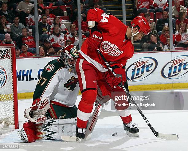 Todd Bertuzzi of the Detroit Red Wings looks for the puck as Josh Harding of the Minnesota Wild gets ready to make a save during an NHL game at Joe...