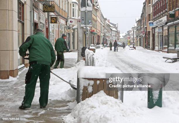 March 2018, Germany, Wernigerode: Snow clearers keep the pavements clear in the city centre. Photo: Matthias Bein/dpa-Zentralbild/dpa