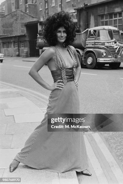 Fashion model Aldine Honey wearing a polka dotted long dress, with plunging neckline and narrow waist, London, UK, 9th September 1969.