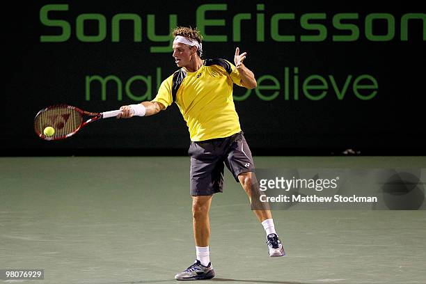 David Nalbandian returns a shot to Viktor Troiki of Serbia during day four of the 2010 Sony Ericsson Open at Crandon Park Tennis Center on March 26,...