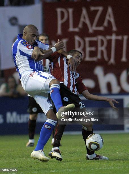 Leandro Benitez of Estudiantes vies for the ball with Ariel Rojas of Godoy Cruz during a match as part of the Torneo Clausura 2010 on March 26, 2010...