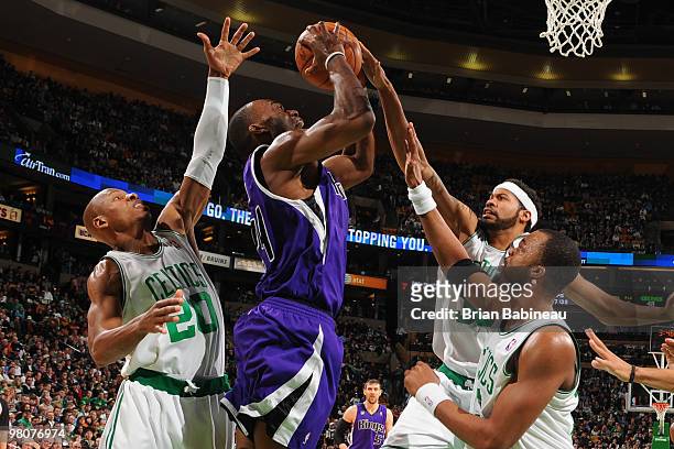 Carl Landry of the Sacramento Kings tries to score against Ray Allen, Rasheed Wallace and Sheldon Williams of the Boston Celtics on March 26, 2010 at...