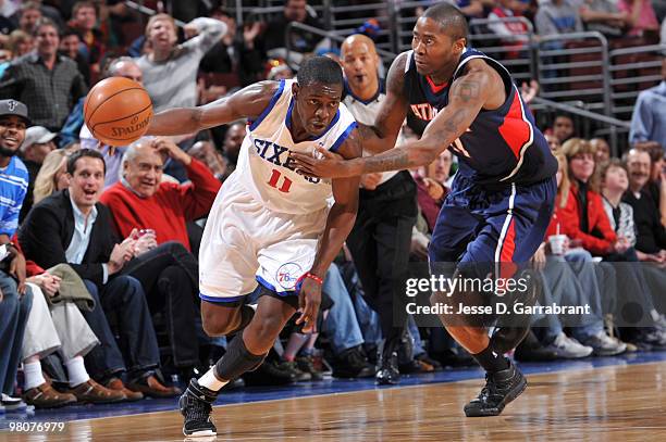 Jrue Holiday of the Philadelphia 76ers drives against Jamal Crawford of the Atlanta Hawks during the game on March 26, 2010 at the Wachovia Center in...