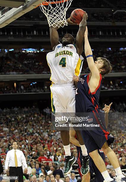 Forward Quincy Acy of the Baylor Bears makes a slam dunk against Matthew Dellavedova of the St. Mary's Gaels during the south regional semifinal of...