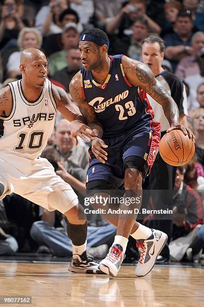 LeBron James of the Cleveland Cavaliers with the ball against Keith Bogans of the San Antonio Spurs at the AT&T Center on March 26, 2010 in San...