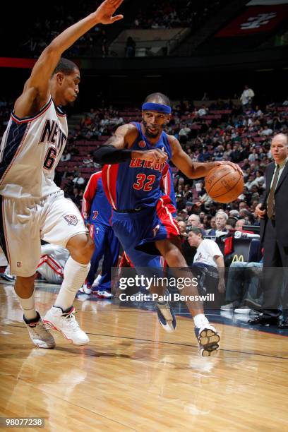 Richard Hamilton of the Detroit Pistons drives against Courtney Lee of the New Jersey Nets during a game on March 26, 2010 at Izod Center in East...