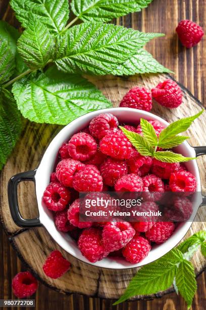 bowl of ripe raspberries - yelena yemchuk stock-fotos und bilder