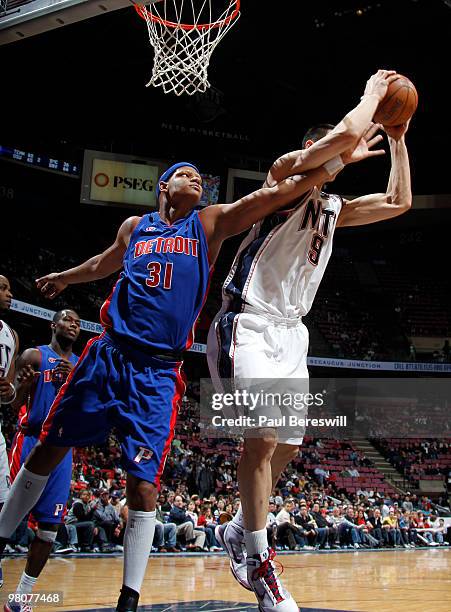 Charlie Villanueva of the Detroit Pistons works for a rebound against Yi Jianlian of the New Jersey Nets during a game on March 26, 2010 at Izod...