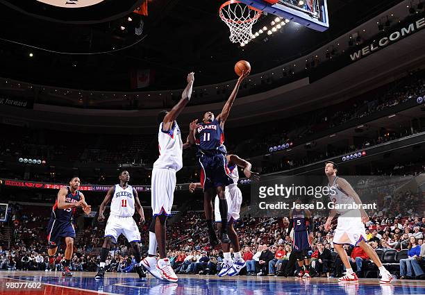 Jamal Crawford of the Atlanta Hawks shoots against Samuel Dalembert of the Philadelphia 76ers during the game on March 26, 2010 at the Wachovia...
