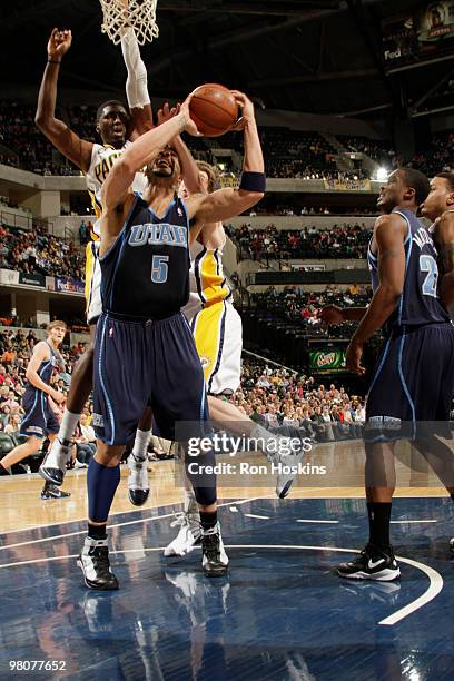 Carlos Boozer of the Utah Jazz battles Roy Hibbert and Troy Murphy of the Indiana Pacers at Conseco Fieldhouse on March 26, 2010 in Indianapolis,...