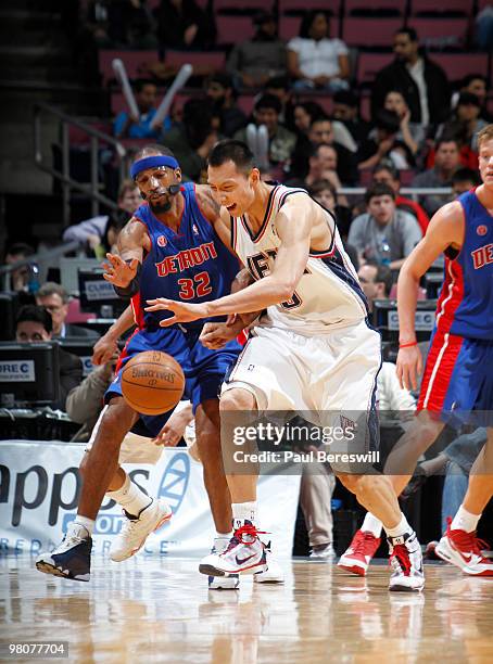 Yi Jianlian of the New Jersey Nets tracks down a loose ball against Richard Hamilton of the Detroit Pistons during a game on March 26, 2010 at Izod...