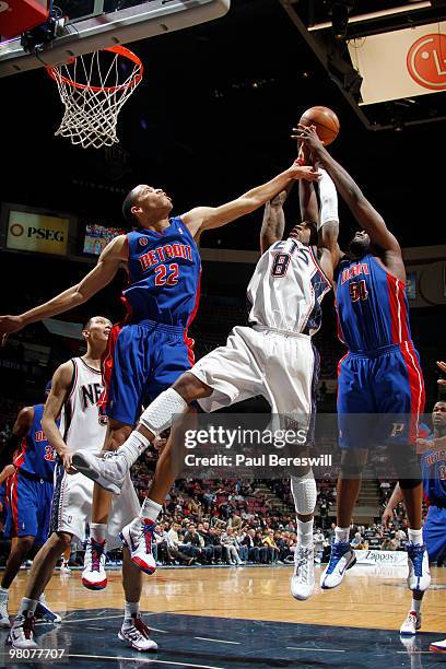 Terrence Williams of the New Jersey Nets shoots against Tayshaun Prince and Jason Maxiell of the Detroit Pistons during a game on March 26, 2010 at...