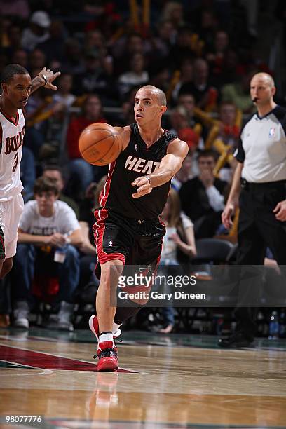 Carlos Arroyo of the Miami Heat passes against Brandon Jennings of the Milwaukee Bucks on March 26, 2010 at the Bradley Center in Milwaukee,...