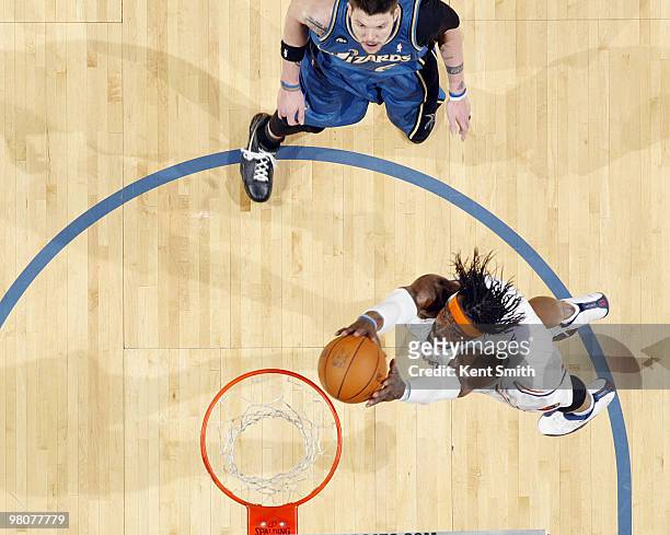 Gerald Wallace of the Charlotte Bobcats dunks against Mike Miller of the Washington Wizards on March 26, 2010 at the Time Warner Cable Arena in...