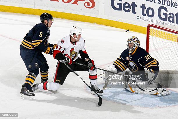 Zack Smith of the Ottawa Senators watches the puck go over the head of Ryan Miller of the Buffalo Sabres as Toni Lydman of the Sabres defends at HSBC...