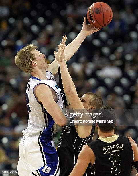 Forward Kyle Singler of the Duke Blue Devils takes a shot against D.J. Byrd of the Purdue Boilermakers during the south regional semifinal of the...