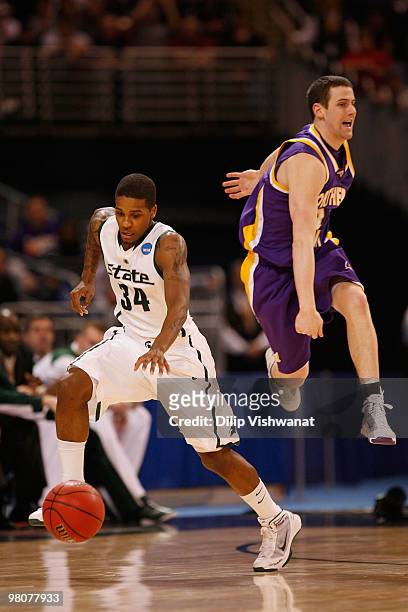 Korie Lucious of the Michigan State Spartans picks up a loose ball against Johhny Moran of the Northern Iowa Panthers during the midwest regional...