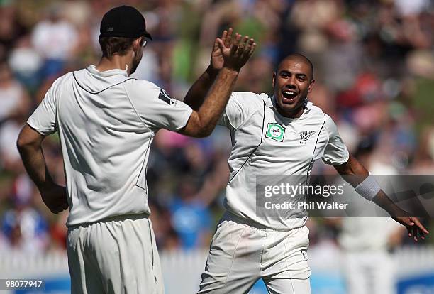 Jeetan Patel of New Zealand celebrates his wicket of Michael Clarke of Australia with Daniel Vettori during day one of the Second Test match between...