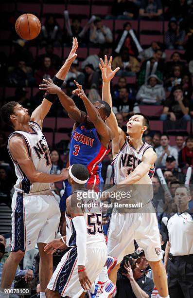 Yi Jianlian and Brook Lopez of the New Jersey Nets defend against Rodney Stuckey of the Detroit Pistons during a game on March 26, 2010 at Izod...