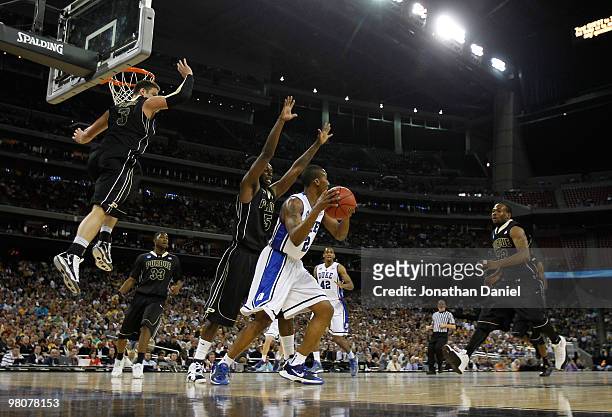 Chris Kramer, Keaton Grant and Lewis Jackson of the Purdue Boilermakers defend against Nolan Smith of the Duke Blue Devils as he looks to pass during...