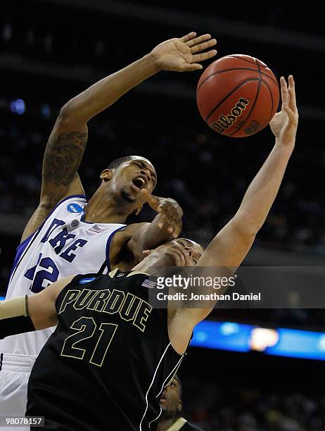 Byrd of the Purdue Boilermakers gets hit while rebounding by Lance Thomas of the Duke Blue Devils during the south regional semifinal of the 2010...